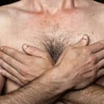 Caucasian man with his hands on his chest