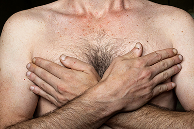 Caucasian man with his hands on his chest