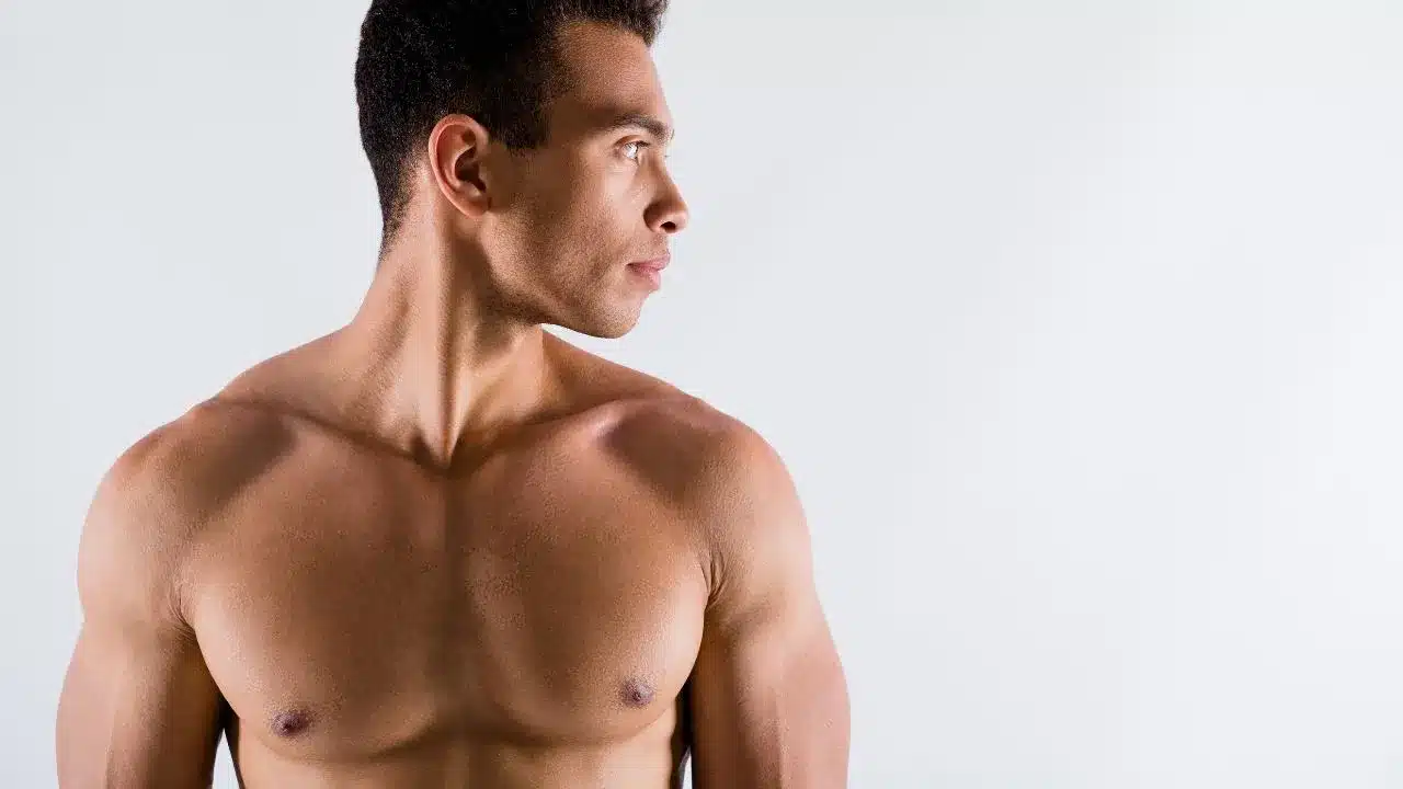 tanned guy looking aside working out